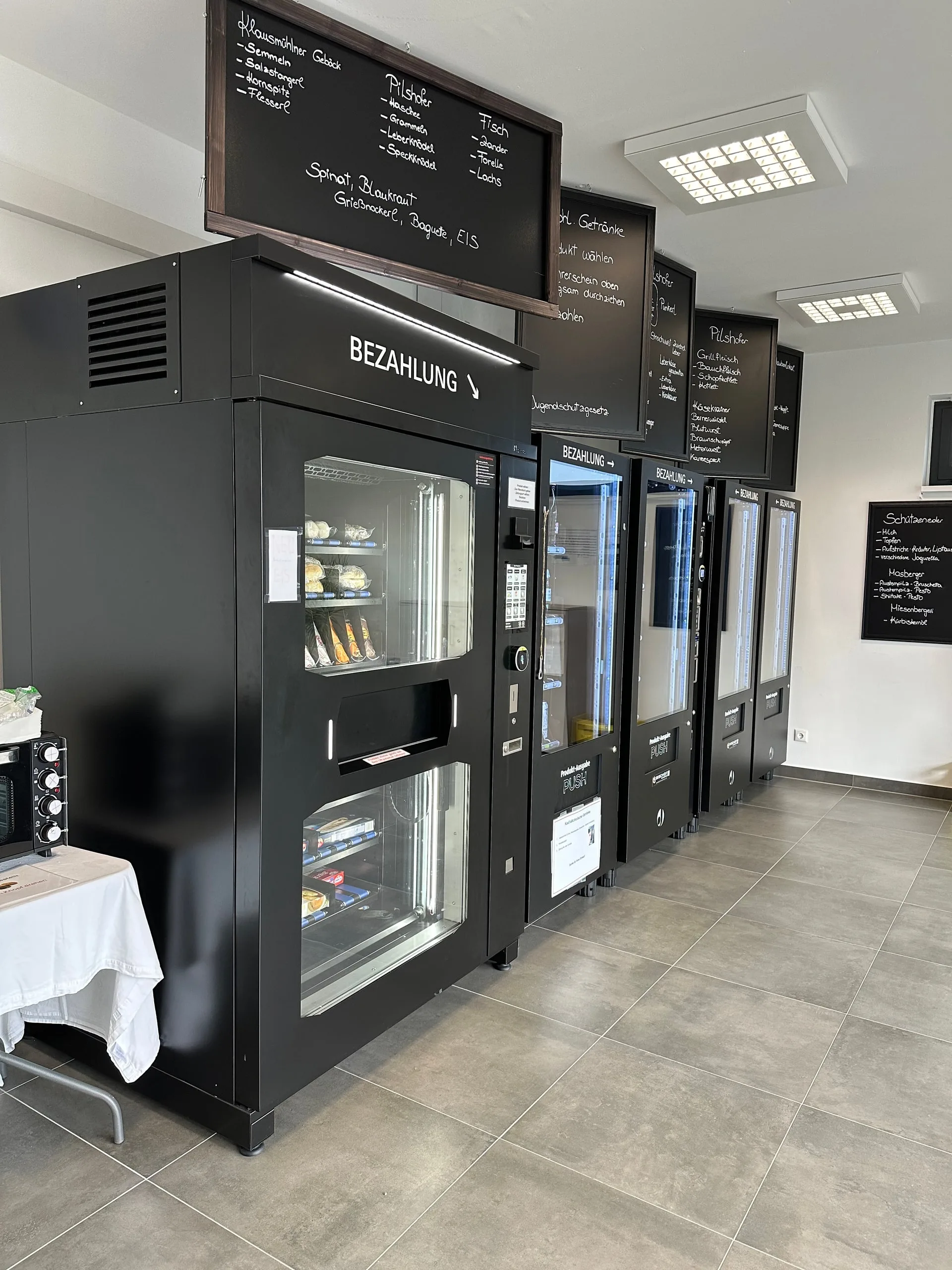 Automaten mit Kreidetafeln, auf denen das Sortiment steht